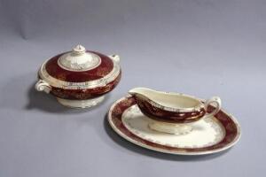 A Ducal ware gilt and maroon bordered dinner service.