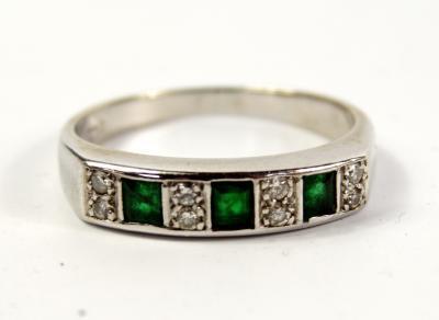 A emerald and diamond half hoop eternity ring