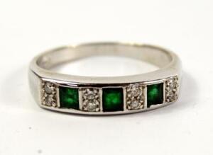 A emerald and diamond half hoop eternity ring