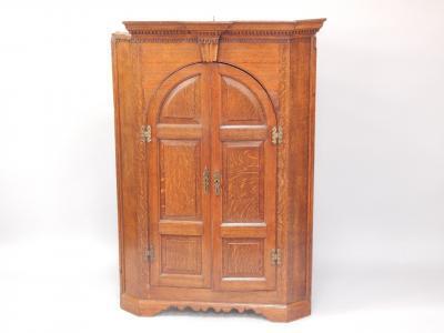 A George III oak hanging corner cupboard