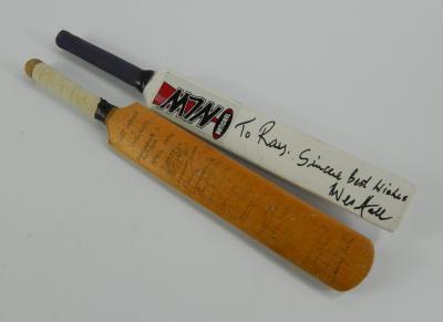 Two miniature cricket bats