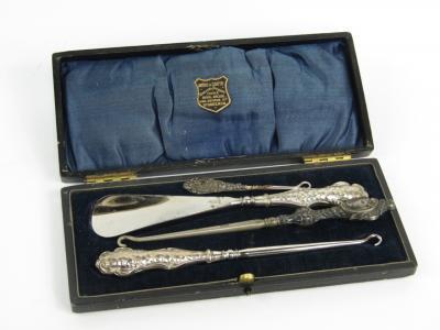 A George V silver handled button hook and shoe horn