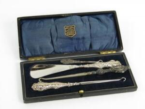A George V silver handled button hook and shoe horn