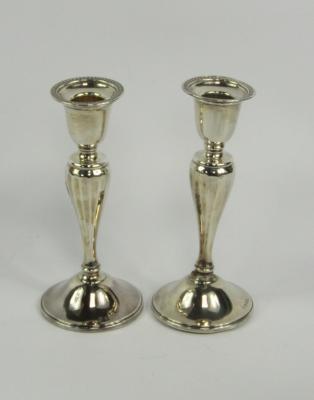 A pair of George V silver loaded candlesticks