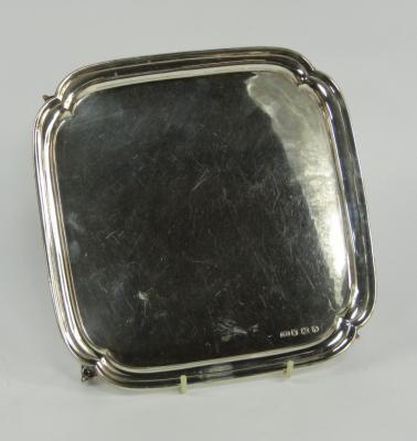 A silver square pie crust salver
