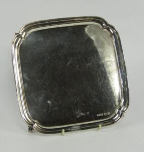 A silver square pie crust salver
