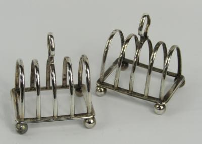 A pair of George V silver four division toast racks