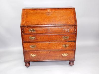 A George III oak and mahogany cross banded bureau
