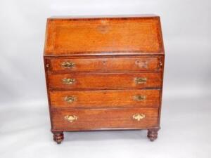 A George III oak and mahogany cross banded bureau