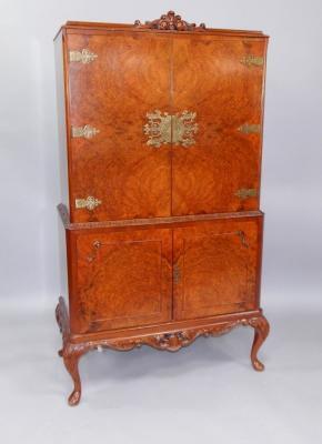 A 1950s walnut cocktail cabinet