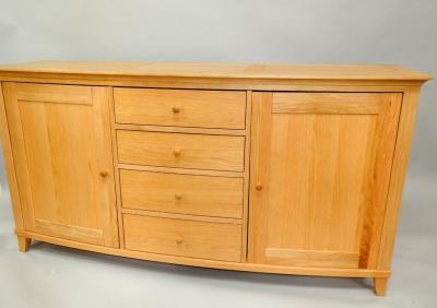 A modern oak bow front sideboard