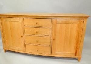 A modern oak bow front sideboard