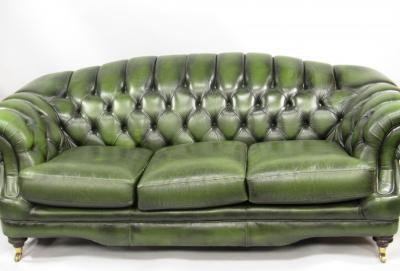 A green buttoned leather scroll sofa
