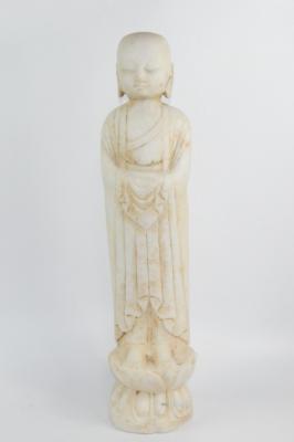 A reconstituted marble figure of Buddha
