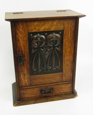 A Victorian Art Nouveau oak and copper smoker's cabinet