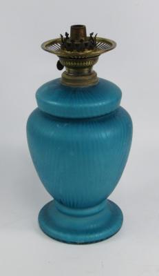 A blue iridescent glass oil lamp