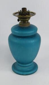 A blue iridescent glass oil lamp
