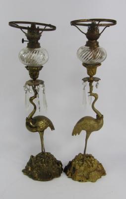 A pair of cast metal oil lamps