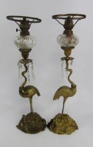 A pair of cast metal oil lamps
