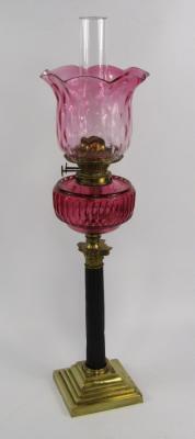 A Duplex brass and blackened metal Corinthian column oil lamp