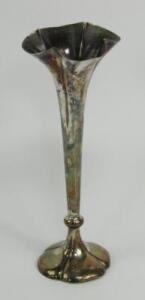 A loaded silver bud vase