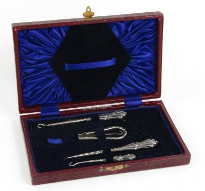 A George V silver and steel four piece button hook set