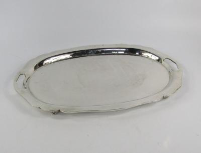 A twin handled and white metal tray