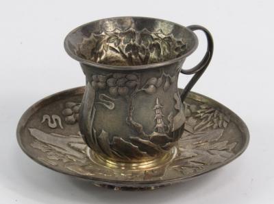 A Chinese white metal coffee cup and saucer