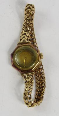 An Omega lady's yellow metal cased wristwatch
