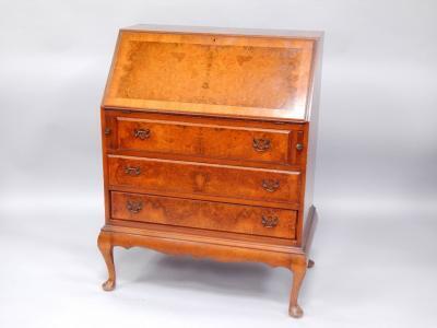 A walnut and cross banded bureau