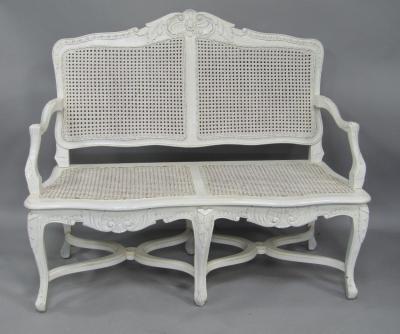A grey painted cane two seater sofa