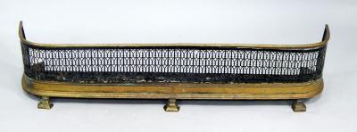A Regency brass and pierced steel fender