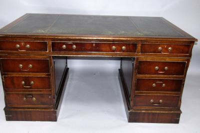 A reproduction mahogany pedestal desk