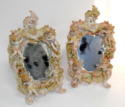 A pair of 19thC continental porcelain strut mirrors