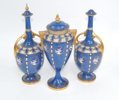A garniture of Royal Worcester porcelain vases and covers