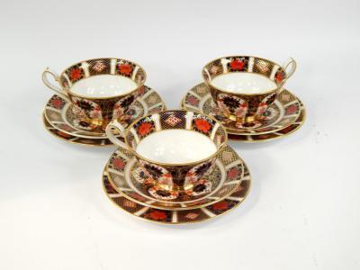 A set of three Royal Crown Derby porcelain trios