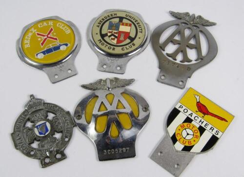 A collection of automobile club badges