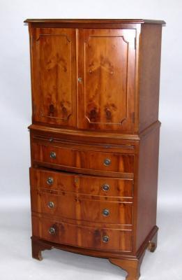 A yew bow fronted cocktail cabinet
