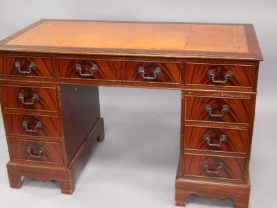 A reproduction mahogany pedestal desk