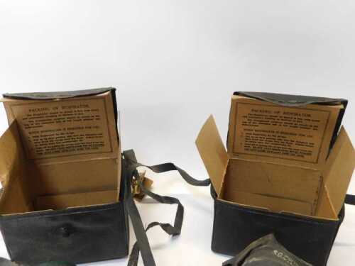 Two World War II gas masks, each bearing paper label for Holland County ...