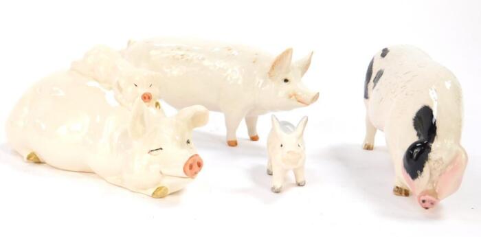 A Beswick pottery figure of a recumbent pig with a piglet on it's back