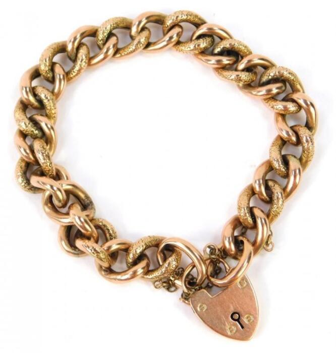 A curb link bracelet on a heart shaped padlock clasp