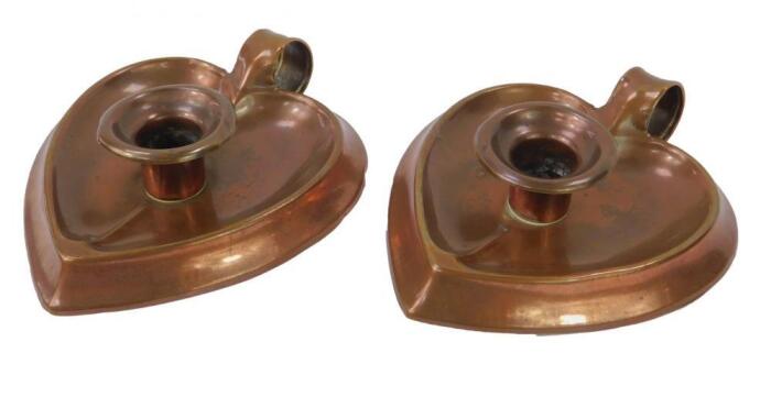 A pair of Joseph Sankey & Son Arts & Crafts copper chamber sticks