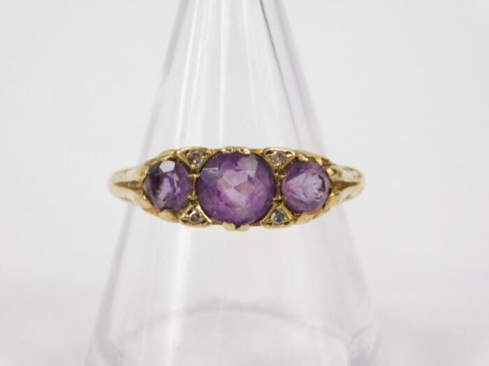 A 9ct gold and amethyst three stone ring