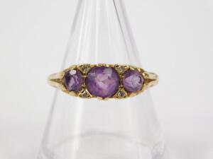 A 9ct gold and amethyst three stone ring