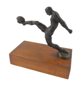 A mid 20thC patinated brass figure of a rugby player