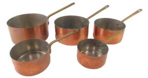 A set of five French copper and brass graduated saucepans