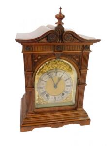 A Victorian walnut cased mantel clock