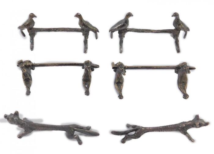 Three pairs of silver plated knife rests