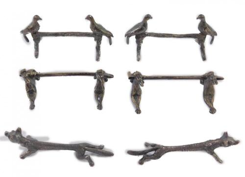 Three pairs of silver plated knife rests